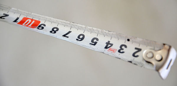 High angle view of measuring tape against white background