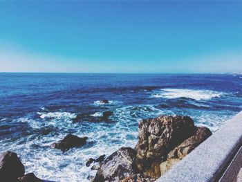 Scenic view of sea against clear blue sky