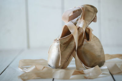 Close-up of white shoes on table