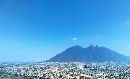 Scenic view of mountains against clear blue sky