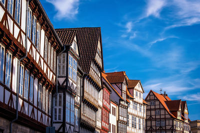 Low angle view of buildings against cloudy sky