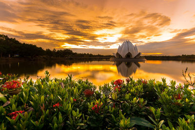 Scenic view of lake against orange sky