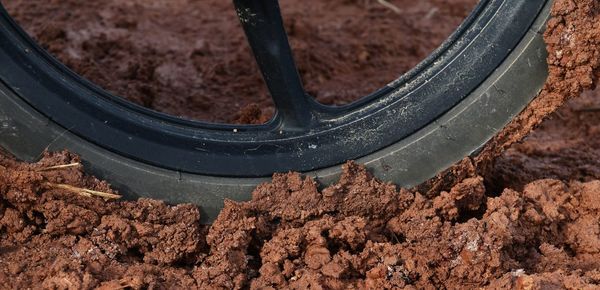 Close-up of bicycle tire in dirt on land