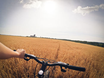 Person riding bicycle on field