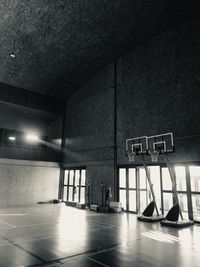 Illuminated basketball hoop on building at night
