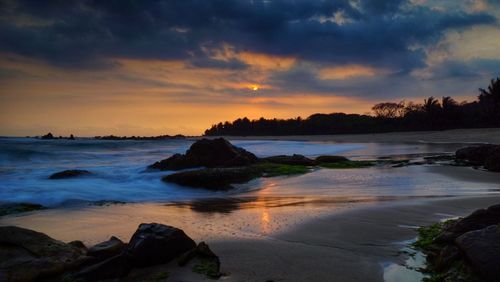 Scenic view of sea against cloudy sky