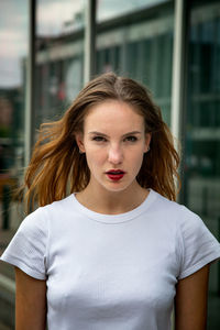 Portrait of young woman standing in city