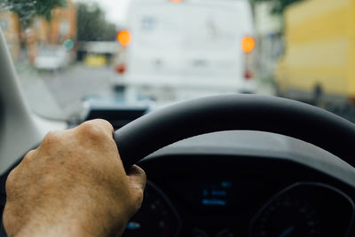 Cropped image of man driving car