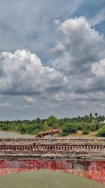 Scenic view of river by building against sky