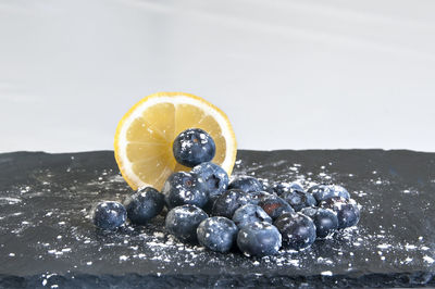 Close-up of fruits on table against white background