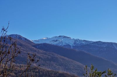 Scenic view of mountains against clear blue sky