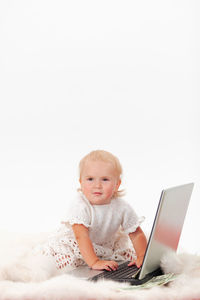 Cute boy using mobile phone on bed