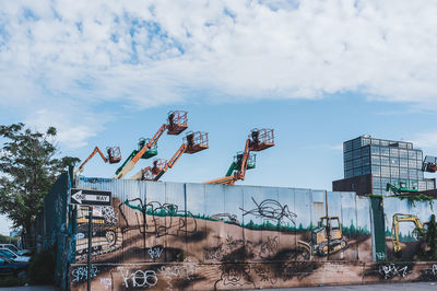 Low angle view of graffiti on building against sky