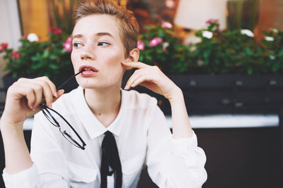 Portrait of woman holding camera