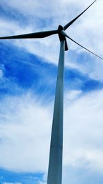 Low angle view of wind turbine against cloudy sky