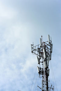 Low angle view of electricity pylon against sky