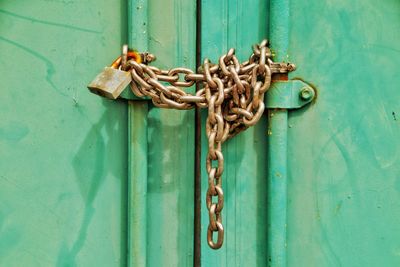 Close-up of closed gate with lock and chain