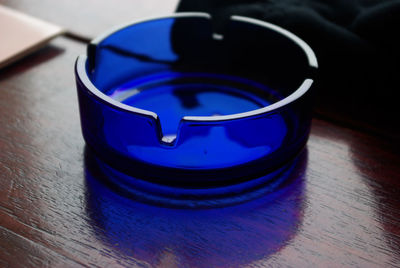 High angle view of blue ashtray on table