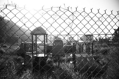 Close-up of barbed wire fence against sky