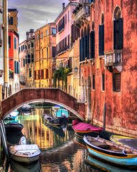 Boats in canal along buildings