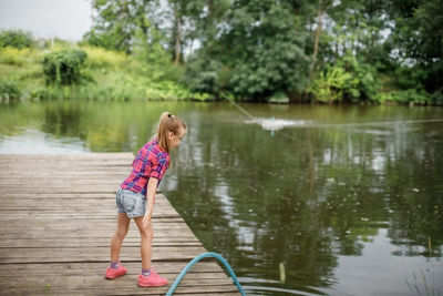 Full length of woman standing in lake