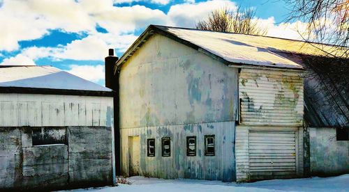 Barn outside house against sky