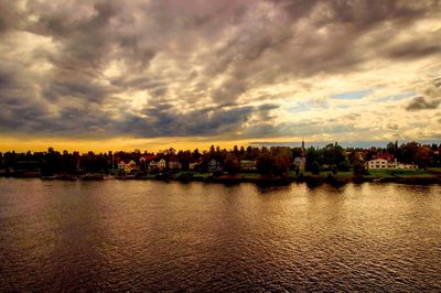 Scenic view of river against sky at sunset