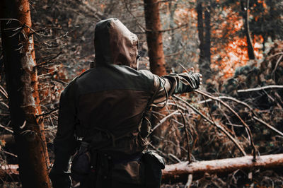 Rear view of man standing in forest