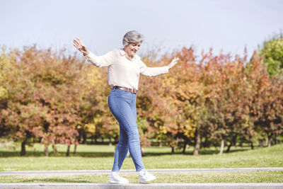 Full length of woman playing on grass