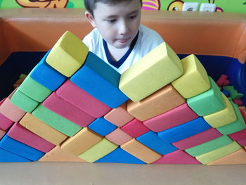 Full length of boy sitting with toy