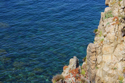 High angle view of rocks by sea