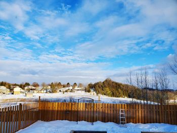 Snow covered houses against sky