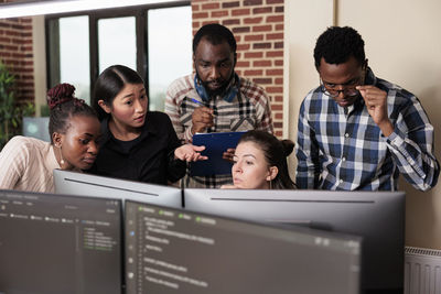 Computer programmers brainstorming at office