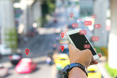 Midsection of person using mobile phone on street