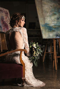 Woman sitting on chair at home