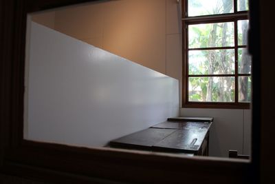Close-up of window on table against wall at home