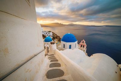 Panoramic view of sea against buildings during sunrise, oia santorini 