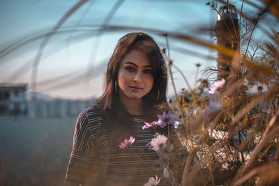 Portrait of young woman standing outdoors