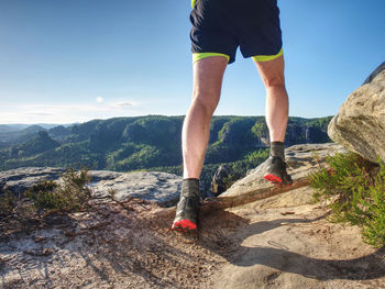 Healthy lifestyle middle aged man runner running on mountain trail in sunset