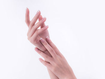 Close-up of woman hand over white background