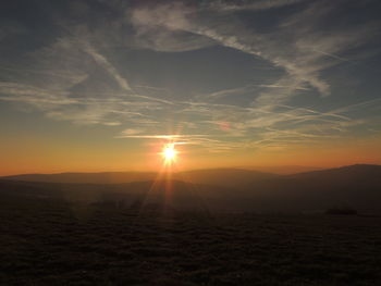 Silhouette landscape against sky during sunset