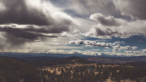 Scenic view of clouds over mountains against sky