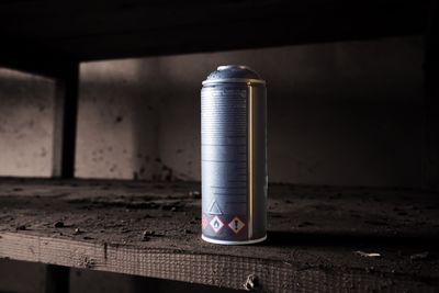 Close-up deodorant can on dirty shelf