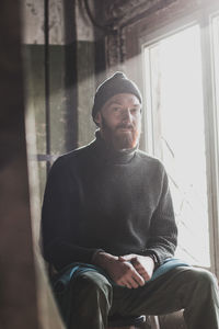 Man looking through window