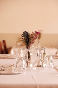 Close-up of glass and vase on the dining table.