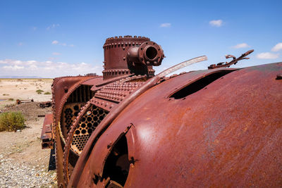 Old rusty wheel against sky