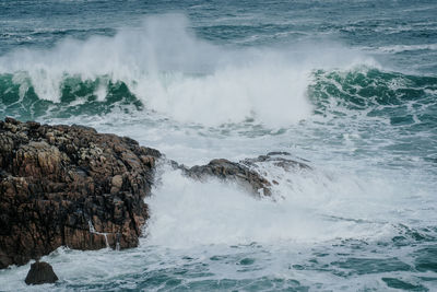 Scenic view of sea against rocks