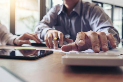 Midsection of business colleagues working in office