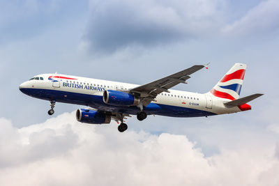 Low angle view of airplane flying against sky