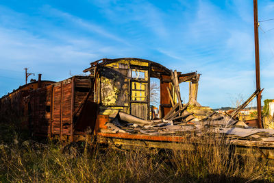 Abandoned broken house against sky